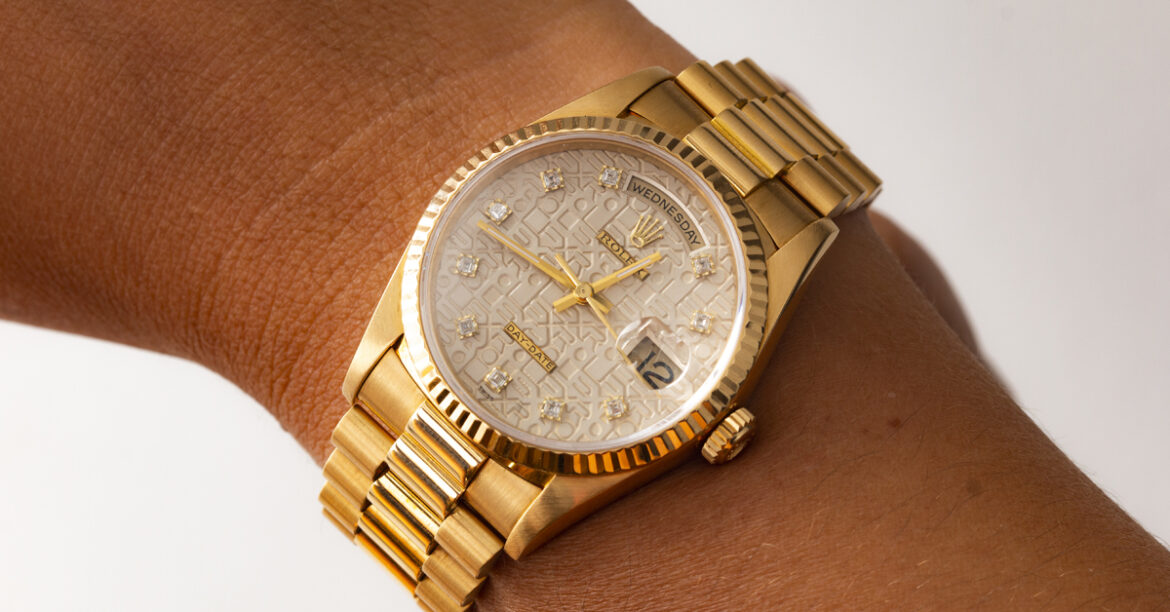 A woman wearing a Rolex Day Date President in gold.