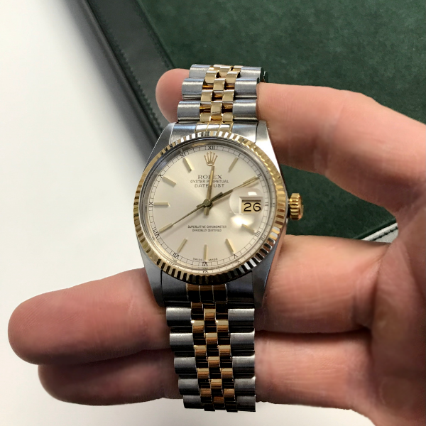Rolex Datejust 16233 stainless steel and gold watch with a silver dial.