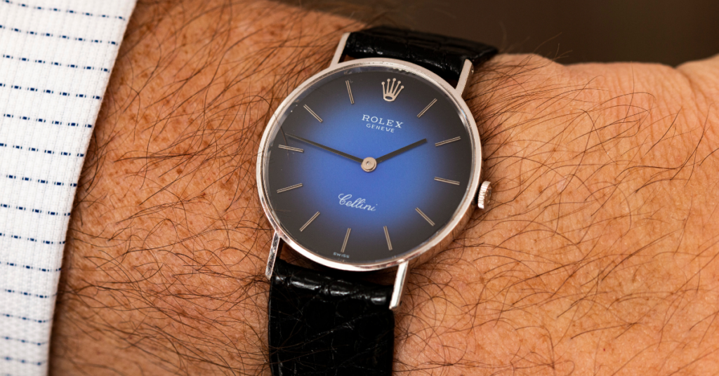 Rolex Cellini with a blue sunburst dial and black leather strap.