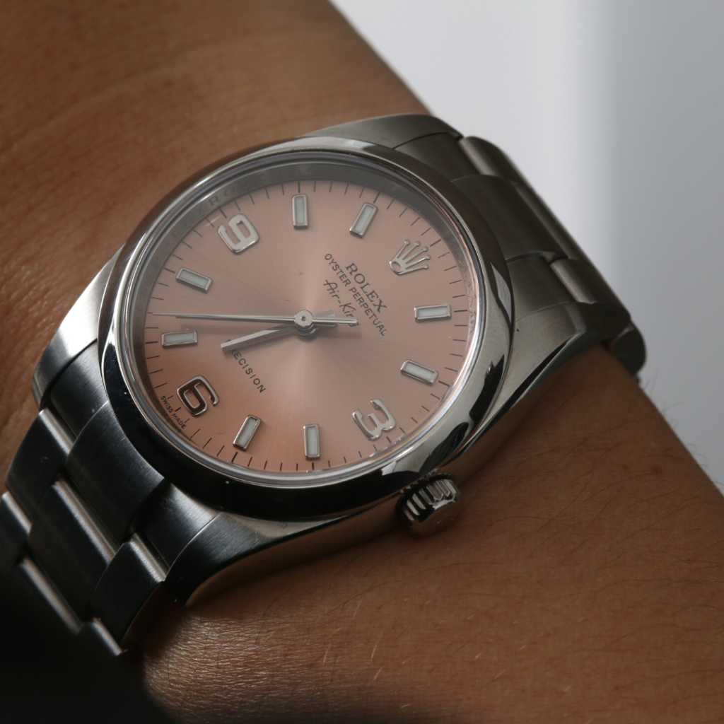 Rolex Air King 114200 with a pink dial and stainless steel case.